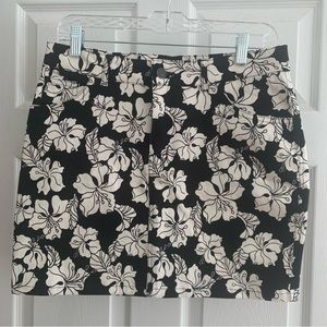 Motel | NWT denim style mini skirt with white florals; front zipper and pockets
